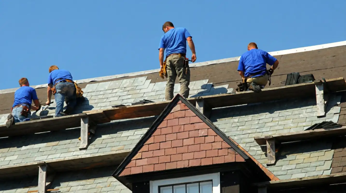 Roof replacement in progress with a team of professional contractors installing new shingles on a residential home in Dayton, OH