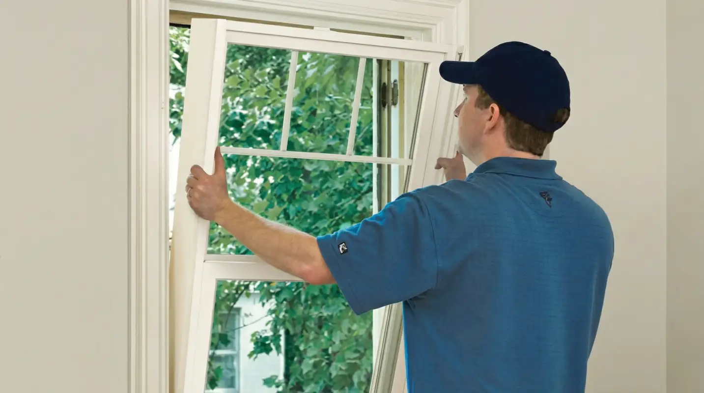 Professional contractors performing a residential window insulation and replacement service in Dayton, OH